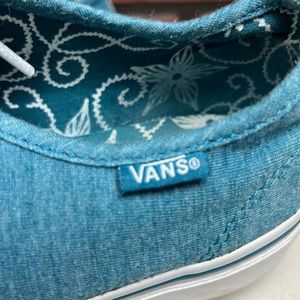 Teal Vans with print floral detail. Lace up